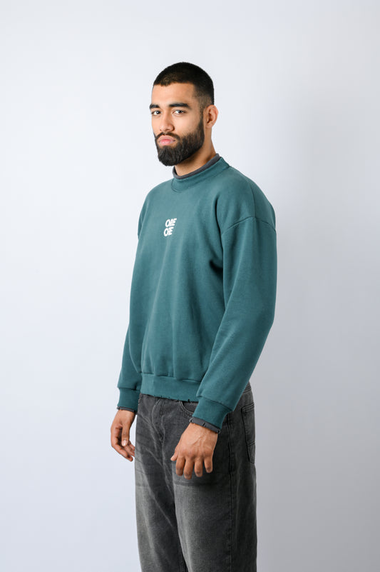 Sweatshirt features multi-color contrast panels in subtle forest Green and Grey