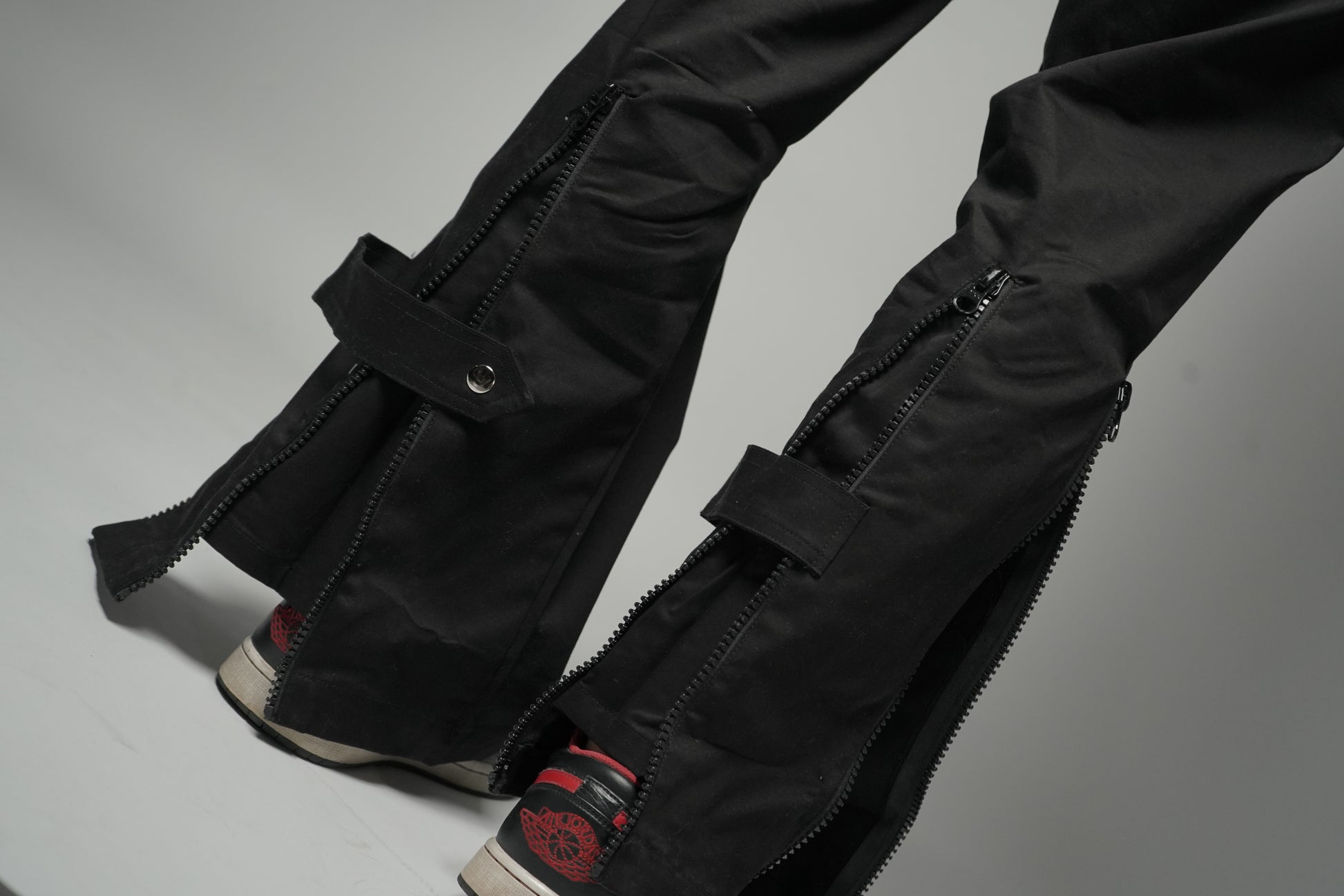 Black Baggy Zipper Pants showing back-flaring zips