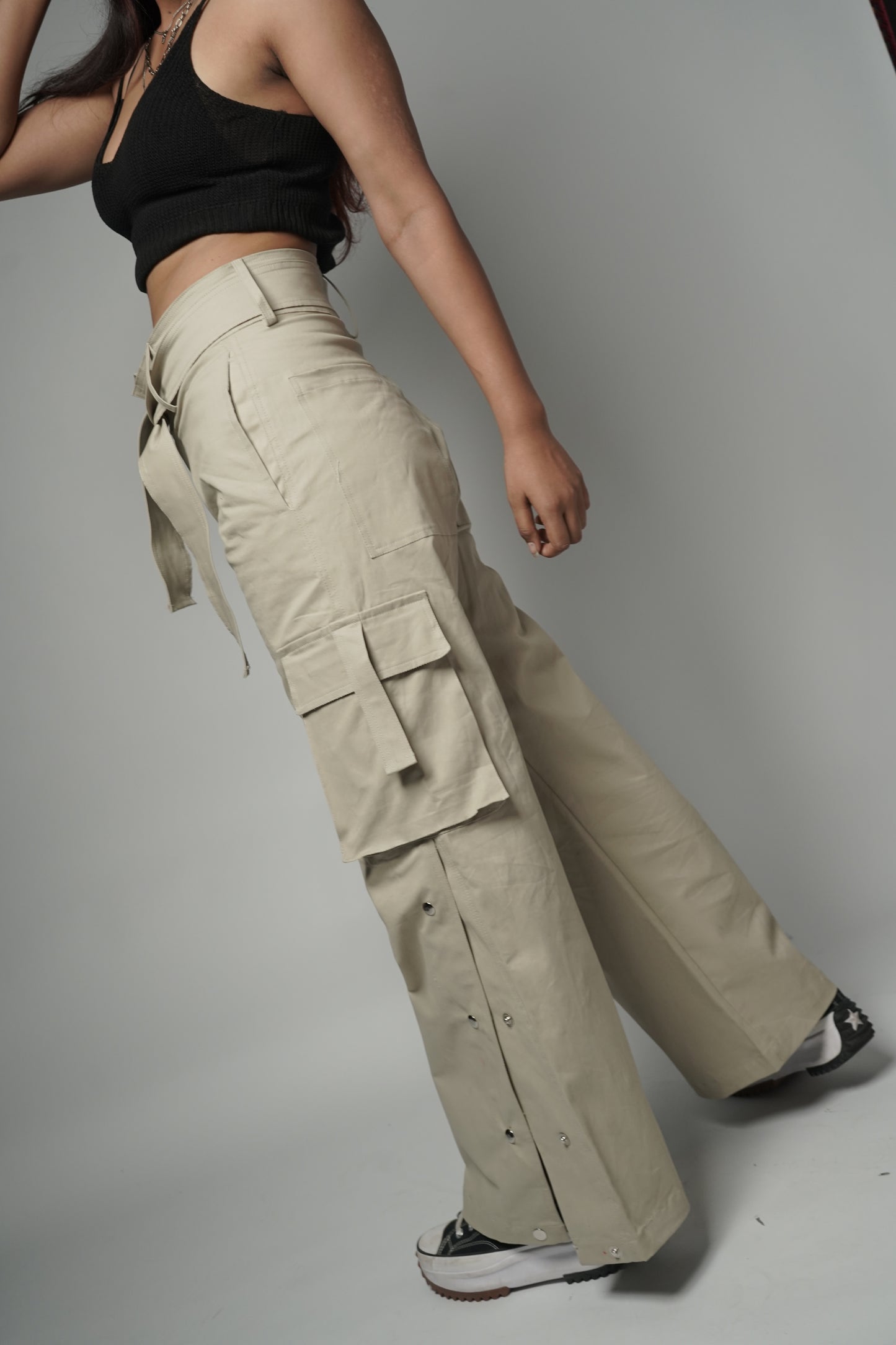 Model wearing unisex Buttoned down Pants, showcasing bottom pant cut.