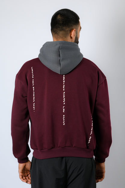 maroon hoodie with a contrasting dark grey hood features a cat strumming the shamisen