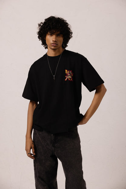 Model wearing Xolotl black Oversized T-shirt with Aztec dog god design, 100% Terry Cotton, embroidery & screen printing.