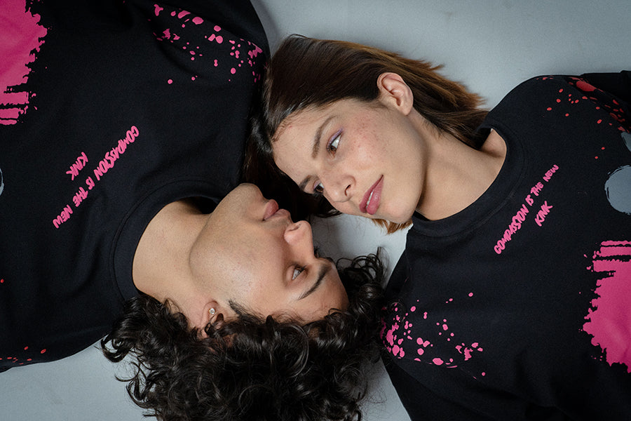 Cargar video: video displays a black printed oversized t-shirt that reads compassion is the new kink